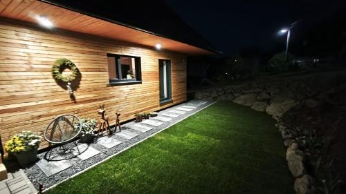 a house with a green lawn in front of it at Happynewhome Slovenský Raj in Hnilčík