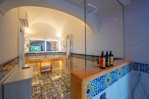a bathroom with two sinks and a shower at Hotel Pellegrino in Praiano