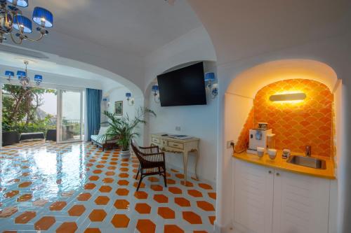 a kitchen with a sink and a table in a room at Hotel Pellegrino in Praiano