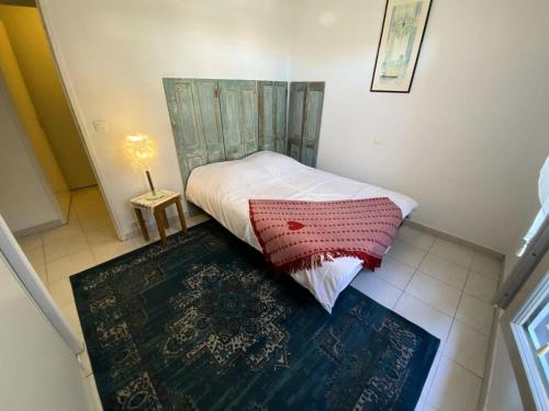una piccola camera da letto con un letto e un tavolo di Résidence Les Vagues - 156 - Appartement en rez de jardin résidence Les Vagues MAE-7381 a Soulac-sur-Mer