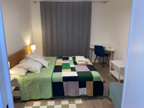a bedroom with a bed with a colorful blanket at The 4 Suns Apartment in Benalmádena