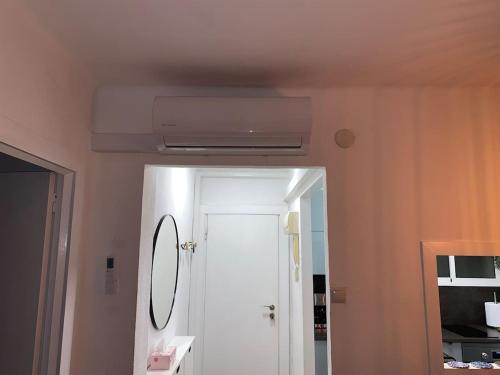 a bathroom with a white door and a mirror at The 4 Suns Apartment in Benalmádena