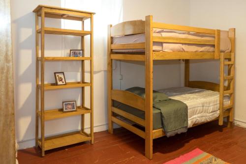 a room with two bunk beds and a chair at Magic House Experience in Cusco
