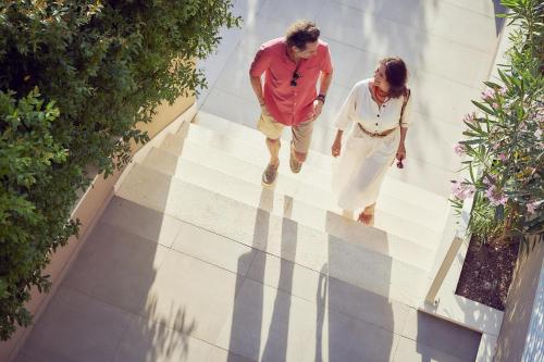a man and a woman walking down the stairs at TUI BLUE Makarska - Adults Only in Igrane