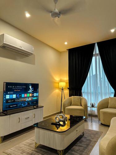 a living room with a tv and a couch and a table at 2 BHK Apartment in ISLAMABAD in Islamabad