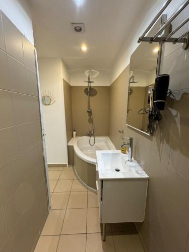 une salle de bain avec un lavabo et une baignoire dans l'établissement appartement centre historique, à Bastia