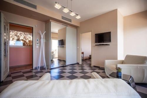a bedroom with a bed and a checkered floor at Seaside Villa Margarita in Akrotiri