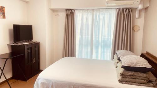 Postel nebo postele na pokoji v ubytování SkyHotel Ryogoku 駅徒歩4分