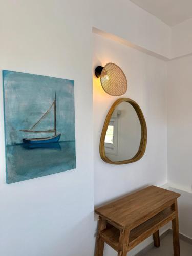 a mirror and a wooden table in a room at PETRA Luxury Villas in Áyioi Apóstoloi