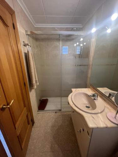 a bathroom with a shower and a sink at La mar de bien in El Perelló
