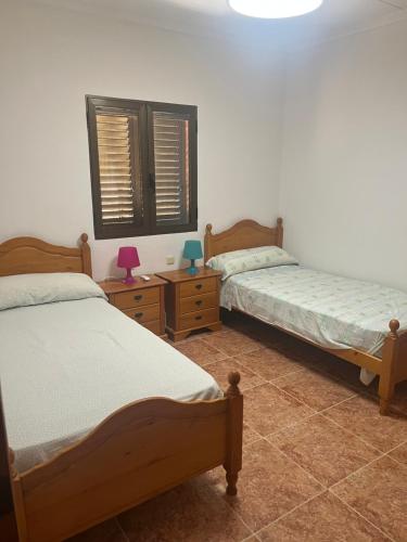 a bedroom with two beds and two night stands at La mar de bien in El Perelló