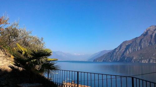 a view of a lake with mountains in the background at Studio Zu - Lakeside Apartment in Riva di Solto