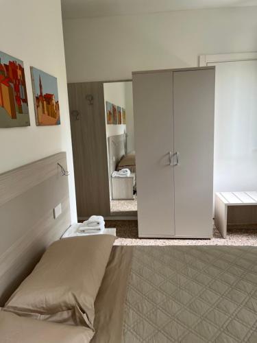 a bedroom with a bed and a large mirror at Casa sulla Laguna CASTELLO in Venice