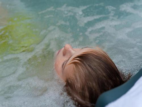 a young child swimming in the water at Comfortable family and friends house with wellness in Vlagtwedde