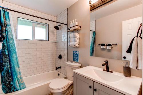a bathroom with a sink and a toilet and a tub at Spacious family home in Littleton with fenced yard in Littleton