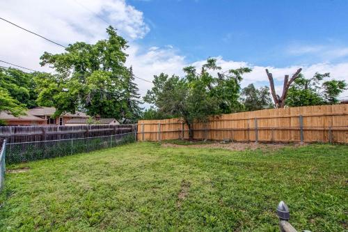 a backyard with a wooden fence and a yard at Spacious family home in Littleton with fenced yard in Littleton