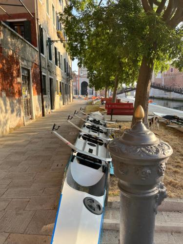 a row of boats lined up next to a pole at Casa sulla Laguna CASTELLO in Venice