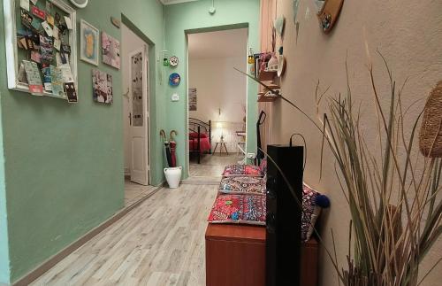 a hallway with a couch in a room with green walls at La Graziosa casetta in Cagliari