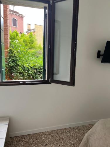 a window in a room with a white wall at Casa sulla Laguna CASTELLO in Venice
