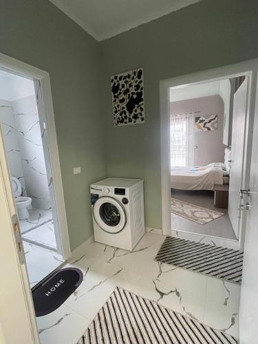 a laundry room with a washing machine and a mirror at The Star House in Pogradec