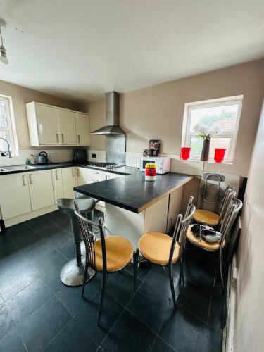 a kitchen with a table and chairs in it at 'Aandal House' Bournemouth' in Parkstone