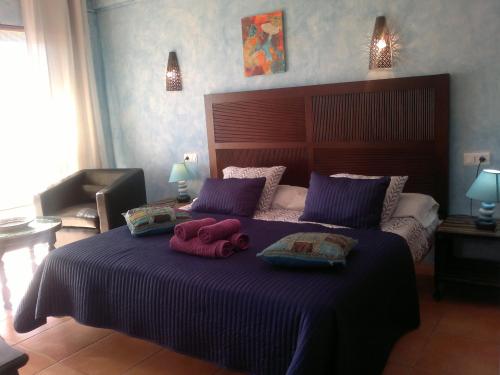 a bedroom with a bed with two stuffed animals on it at Hostal Don Peque Adult Recommended in Nerja