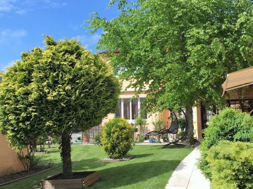 two trees in a yard next to a building at Hôtel et Appart 'hôtel Chez Gino ETAPLES-Le Touquet in Étaples