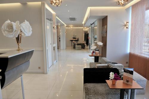 a lobby with chairs and tables in a building at Mercure Paris Place d'Italie in Paris