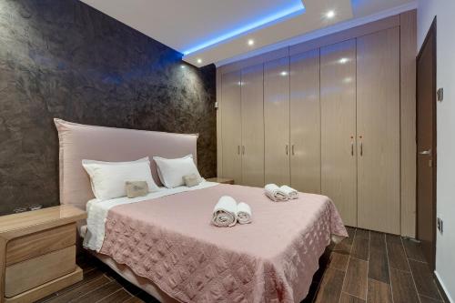 a bedroom with a bed with towels on it at Aphrodites House Upon White Tower in Thessaloniki