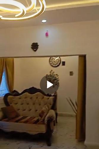 a living room with a couch and a chandelier at Luxury 3 Bedroom Bungalow in Enugu