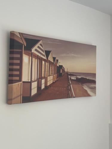 a painting of a boardwalk on the beach at The Cheriton - next to hospital, fast wifi in Bournemouth