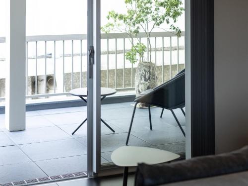 a room with a balcony with a table and a chair at noma - Vacation STAY 21501v in Gifu