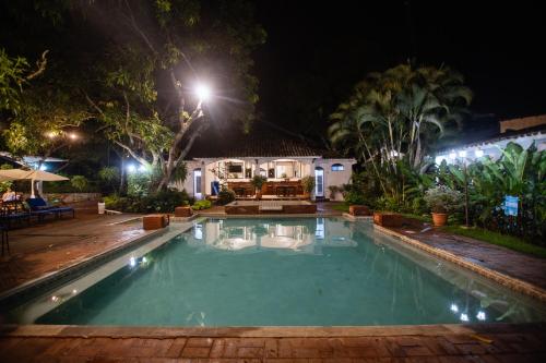 a swimming pool in a yard at night at Hotel Las Marías in Taxisco