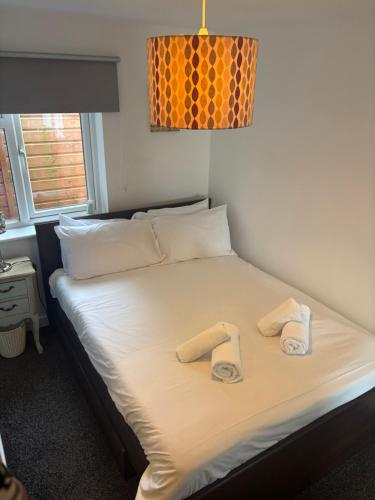 a bed in a room with two towels on it at The Cheriton - next to hospital, fast wifi in Bournemouth