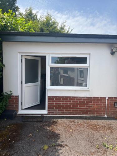 a garage with a door and a window at The Cheriton - next to hospital, fast wifi in Bournemouth