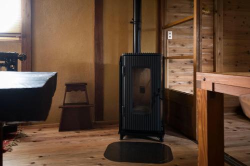 a room with a wood stove in the corner of a room at Eye show - Vacation STAY 78363v in Tsukuba