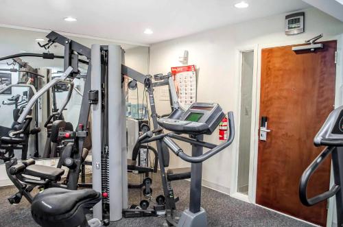 a gym with several tread machines in a room at Super 8 by Wyndham New Cumberland in New Cumberland
