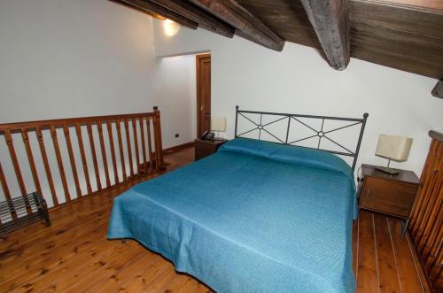 a bedroom with a bed with a blue blanket at Antico Rione in Caltanissetta