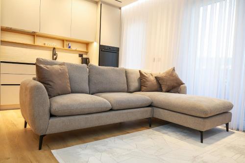 a couch sitting in a living room at Premium Centre Apartment in Peje