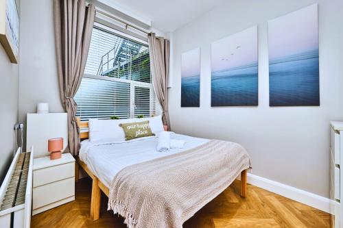 a bedroom with a bed and a window at West Beach 1 - dog friendly - Portrush by the Sea in Portrush