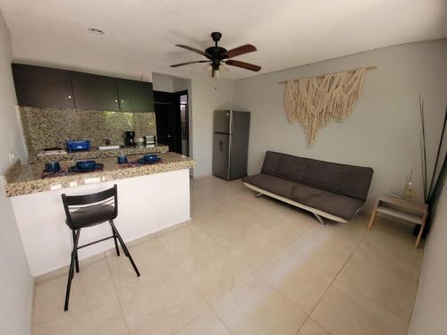 a living room with a couch and a kitchen at Saela Hotel Boutique in Playa del Carmen