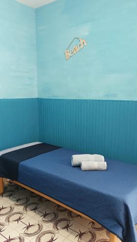 a bedroom with a bed with two towels on it at LA TERRAZZA SUL MARE camera doppia vicino aereoporto&mare SICILIAN SEA STYLE ROOM in Cinisi