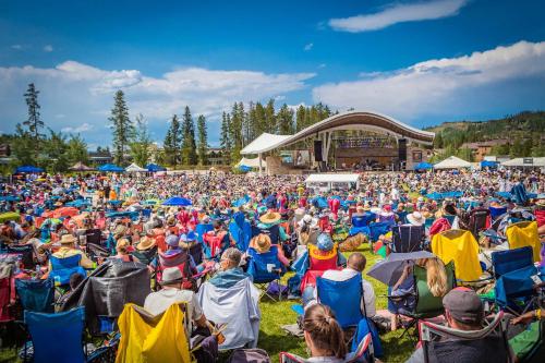 a large crowd of people sitting in chairs at a concert at Gather & Glow in Winter Park