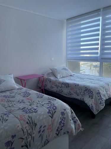 Ein Bett oder Betten in einem Zimmer der Unterkunft Depto en Sunset Arena Concón