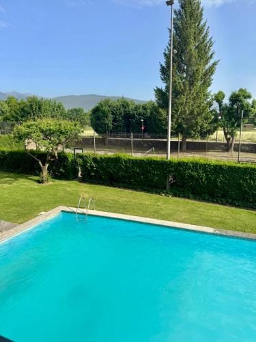 a large blue swimming pool in a park at CAL QuEROL LlíViA - Piscina in Llivia