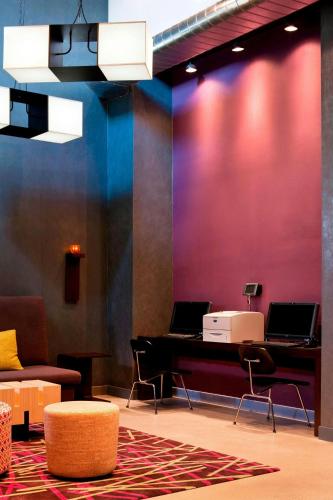 a room with a desk with two laptops on it at Aloft New York Brooklyn in Brooklyn