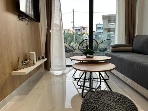a living room with two tables and a couch at Diamond 3 in Kallithea Halkidikis