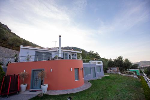 a small house with a balcony on top of it at Mytilene Luxury Villa Panoramic in Mytilini
