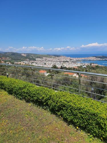 a fence on a hill with a view of the city at Mytilene Luxury Villa Panoramic in Mytilini