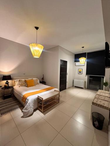 a bedroom with a large bed and two lights at Mytilene Luxury Villa Panoramic in Mytilini